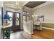 Elegant foyer with double doors, hardwood floors, and a view of the dining area at 25510 High Hampton Cir, Sorrento, FL 32776
