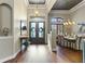 Grand foyer with high ceilings, wood floors, and elegant double doors with stained glass at 25510 High Hampton Cir, Sorrento, FL 32776