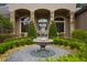 Beautiful stone fountain and lush landscaping welcome visitors to this elegant home at 25510 High Hampton Cir, Sorrento, FL 32776