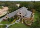 Stone and stucco exterior, paver driveway, lush landscaping, water fountain, and trees at 25510 High Hampton Cir, Sorrento, FL 32776