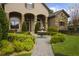 Charming home with stone accents, a water fountain, and a landscaped pathway at 25510 High Hampton Cir, Sorrento, FL 32776
