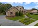 Lovely home with a stone and stucco exterior, paver driveway, and lush landscaping at 25510 High Hampton Cir, Sorrento, FL 32776