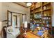 Home office with built-in bookshelves, a wooden desk, and plush seating at 25510 High Hampton Cir, Sorrento, FL 32776