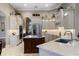 Bright kitchen featuring a large island, white cabinetry, and stainless steel appliances at 25510 High Hampton Cir, Sorrento, FL 32776