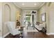 Living room with white couch, coffee table, and view of the backyard through sliding glass doors at 25510 High Hampton Cir, Sorrento, FL 32776