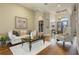 Living room with plush white couch, decorative coffee table, and hardwood floors at 25510 High Hampton Cir, Sorrento, FL 32776