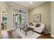 Living room with hardwood floors, a plush white sofa, and access to the patio at 25510 High Hampton Cir, Sorrento, FL 32776