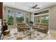 Living room with large windows, comfortable seating, and access to the screened patio at 25510 High Hampton Cir, Sorrento, FL 32776