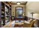 Home office with built-in bookshelves, large window with shutters, and classic furnishings at 25510 High Hampton Cir, Sorrento, FL 32776