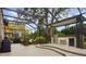 Outdoor kitchen under a screened enclosure with seating area at 25510 High Hampton Cir, Sorrento, FL 32776