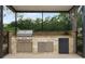 Outdoor kitchen with built-in grill, refrigerator, and ample counter space at 25510 High Hampton Cir, Sorrento, FL 32776