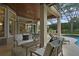 Spacious screened patio with seating area, pool, and lush landscaping at 25510 High Hampton Cir, Sorrento, FL 32776