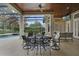 Screened-in patio with dining table, ceiling fan, and pool view at 25510 High Hampton Cir, Sorrento, FL 32776