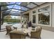 Pool area with screened enclosure, patio furniture, and view of the home at 25510 High Hampton Cir, Sorrento, FL 32776