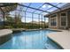 Inviting pool with spa, waterfall feature, and screened enclosure at 25510 High Hampton Cir, Sorrento, FL 32776