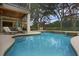Inviting pool with waterfall feature and screened enclosure at 25510 High Hampton Cir, Sorrento, FL 32776