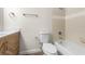 Updated bathroom with wood vanity, white toilet and bathtub at 3034 Parkway Blvd # 204, Kissimmee, FL 34747