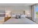 Spacious bedroom with upholstered headboard, nightstands, and large window at 402 Cinnamon Dr, Poinciana, FL 34759
