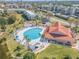 Community pool with lounge chairs, a covered area, and surrounding greenery at 445 Bouchelle Dr # 202, New Smyrna Beach, FL 32169