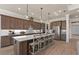 Modern kitchen with large island and pendant lighting at 5154 Foothills Preserve Loop, Mount Dora, FL 32757