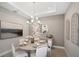 Elegant dining room with a round table, chandelier, and statement artwork at 5338 Spoonflower Ct, Saint Cloud, FL 34771