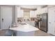 Modern kitchen with white cabinets, stainless steel appliances, and expansive island at 5338 Spoonflower Ct, Saint Cloud, FL 34771