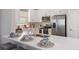Modern kitchen with white cabinets, stainless steel appliances, and expansive island at 5338 Spoonflower Ct, Saint Cloud, FL 34771