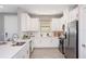 Modern kitchen with white cabinets, stainless steel appliances, and expansive island at 5338 Spoonflower Ct, Saint Cloud, FL 34771