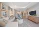 Bright living room features stylish furniture and a view into the kitchen at 5338 Spoonflower Ct, Saint Cloud, FL 34771