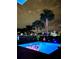 Inviting pool at night with colorful flamingo floats at 8056 Shaker St, Kissimmee, FL 34747