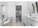 Modern bathroom with a double vanity, toilet, and view to a bedroom at 10140 Cypress Vine Dr, Orlando, FL 32827