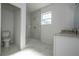 Bathroom boasts a large shower and granite countertop vanity at 1215 Atlantic Ct, Poinciana, FL 34759