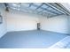 Clean garage with painted floor and open garage door at 1215 Atlantic Ct, Poinciana, FL 34759