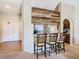 Breakfast bar with three stools, adjacent to kitchen at 1218 Coda Ct, Dundee, FL 33838