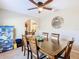 Formal dining room with wood table and chairs, ceiling fan at 1218 Coda Ct, Dundee, FL 33838