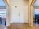 Home entry with double doors, tile flooring, and arched hallways at 1218 Coda Ct, Dundee, FL 33838