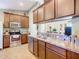 Kitchen with stainless steel appliances and brown wooden cabinets at 1218 Coda Ct, Dundee, FL 33838