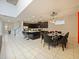 Kitchen and dining area with an island and dark cabinets at 1800 Sawyer Palm Pl, Kissimmee, FL 34747