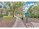 Paved pathway winds through a tranquil park with mature trees at 1825 E Kaley Ave, Orlando, FL 32806