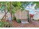 Metal storage shed with ramp access in a backyard garden setting at 2009 Appian Ct, Deltona, FL 32725