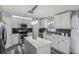 Modern kitchen with white cabinets, island, and stainless steel appliances at 2009 Appian Ct, Deltona, FL 32725