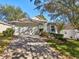 Charming house exterior with a large tree and well-maintained landscaping at 2302 Edmonton Ct, Clermont, FL 34711