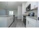 Modern kitchen with white cabinets and stainless steel appliances at 234 Elm Ct Ct, Kissimmee, FL 34759