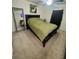 Comfortable bedroom with a queen-size bed, full-length mirror, and ceiling fan at 2810 Plaza Terrace Dr # 2810, Orlando, FL 32803