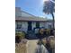 Bright white exterior of a condo with a walkway and tropical landscaping at 2810 Plaza Terrace Dr # 2810, Orlando, FL 32803