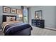 Bedroom with a twin-size bed, dresser, and nautical-themed decor at 2952 Waterlily Way, Poinciana, FL 34759