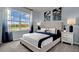 Bright bedroom with a queen-size bed, nightstands, and large window at 2952 Waterlily Way, Poinciana, FL 34759