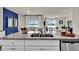 Kitchen boasts granite countertops, white cabinets, and a double sink at 2952 Waterlily Way, Poinciana, FL 34759