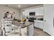 Kitchen features white cabinets, granite island, and stainless steel appliances at 2952 Waterlily Way, Poinciana, FL 34759