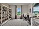 Home office with two desks, chairs, and built-in shelving at 2952 Waterlily Way, Poinciana, FL 34759